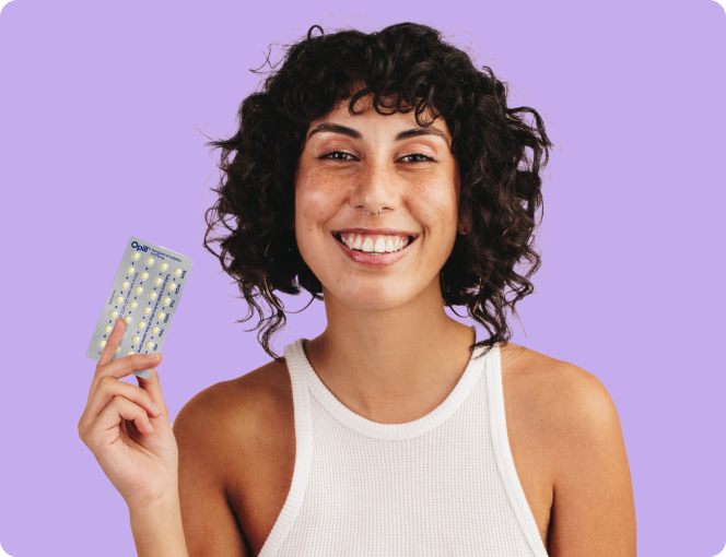 Woman holding Opill contraceptive pills